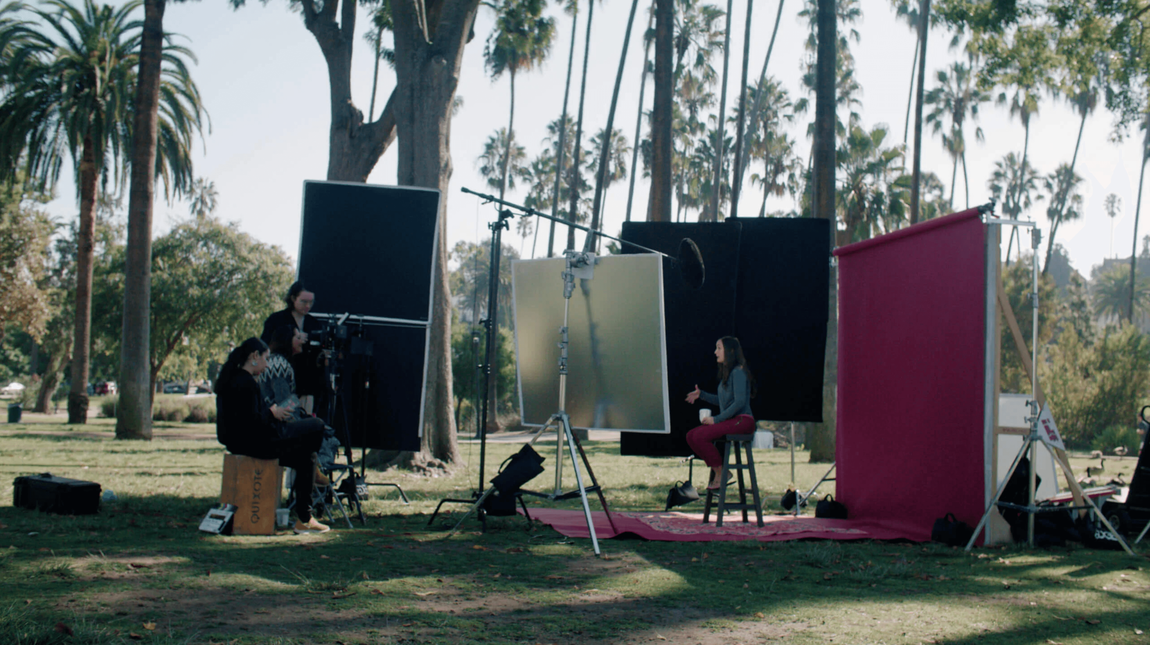 Interview taking place outdoors with woman and a cameraman